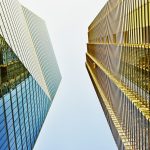 UK, London, looking up at high rise corporate buildings and skyscrapers in the city against clear sky